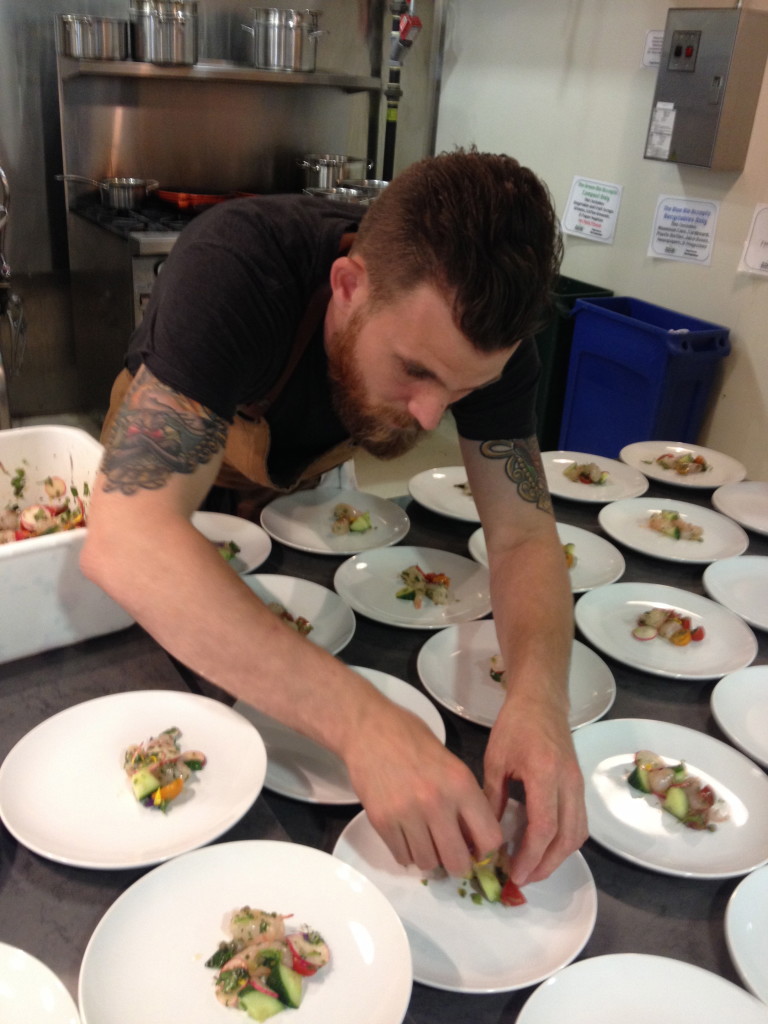 Chef Dale MacKay prepares pan roasted halibut for guests at GE Café Series