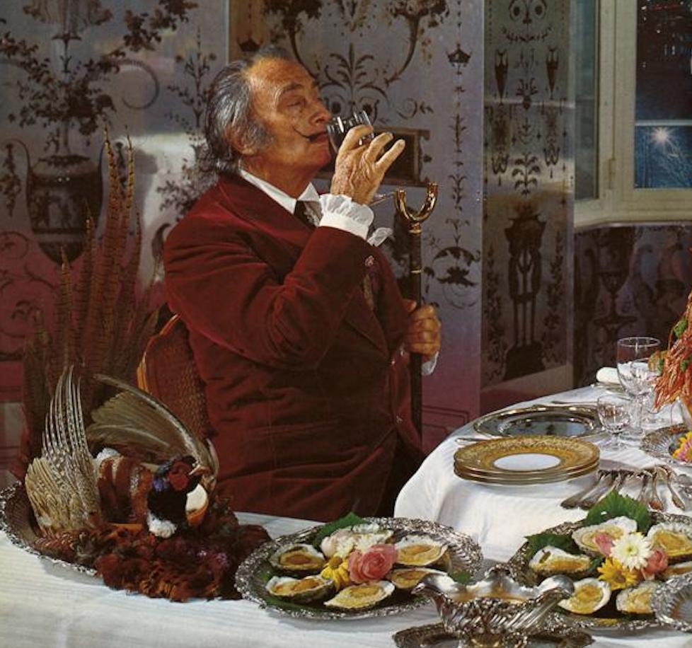 Salvador Dali enjoys a glass of wine