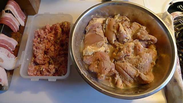 Lining the pan with lard and bacon, mixing the ground pork, leeks, and herbs, and marinating the pheasant, pork cutlets, and chicken thighs in icewine, lemon juice, and garlic.