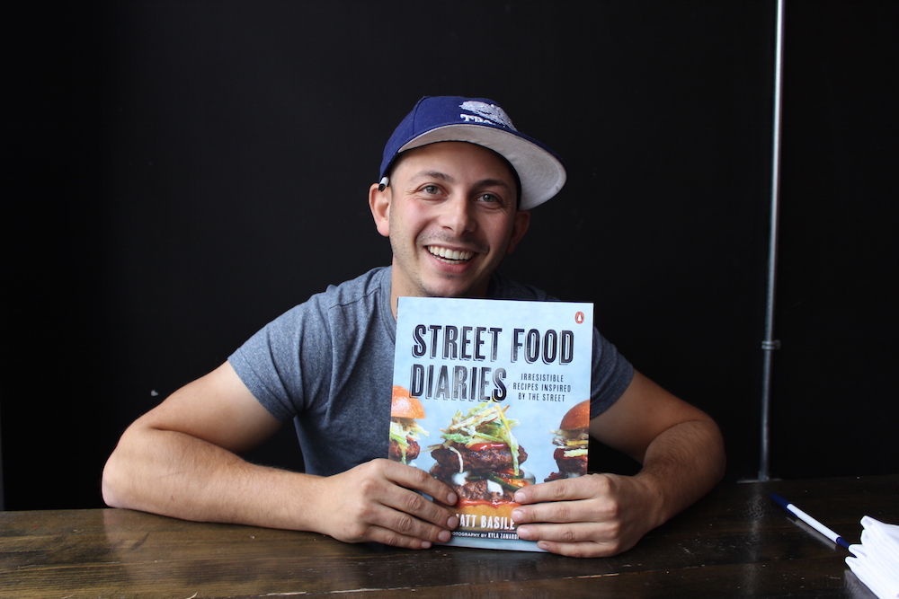 Matt Basile holds his Street Food Diaries cookbook