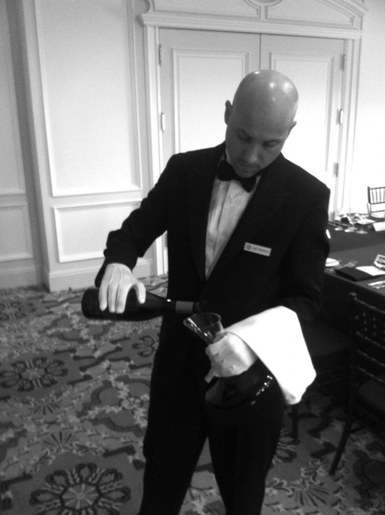 Sommelier Gint Prunskus hard at work in some rather natty white gloves.