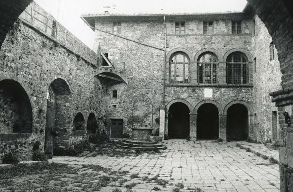 The courtyard with battlements, well and a loggia before Charlotte's restoration.